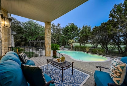 View of backyard pool from luxury home, typical of Lakeway, Austin